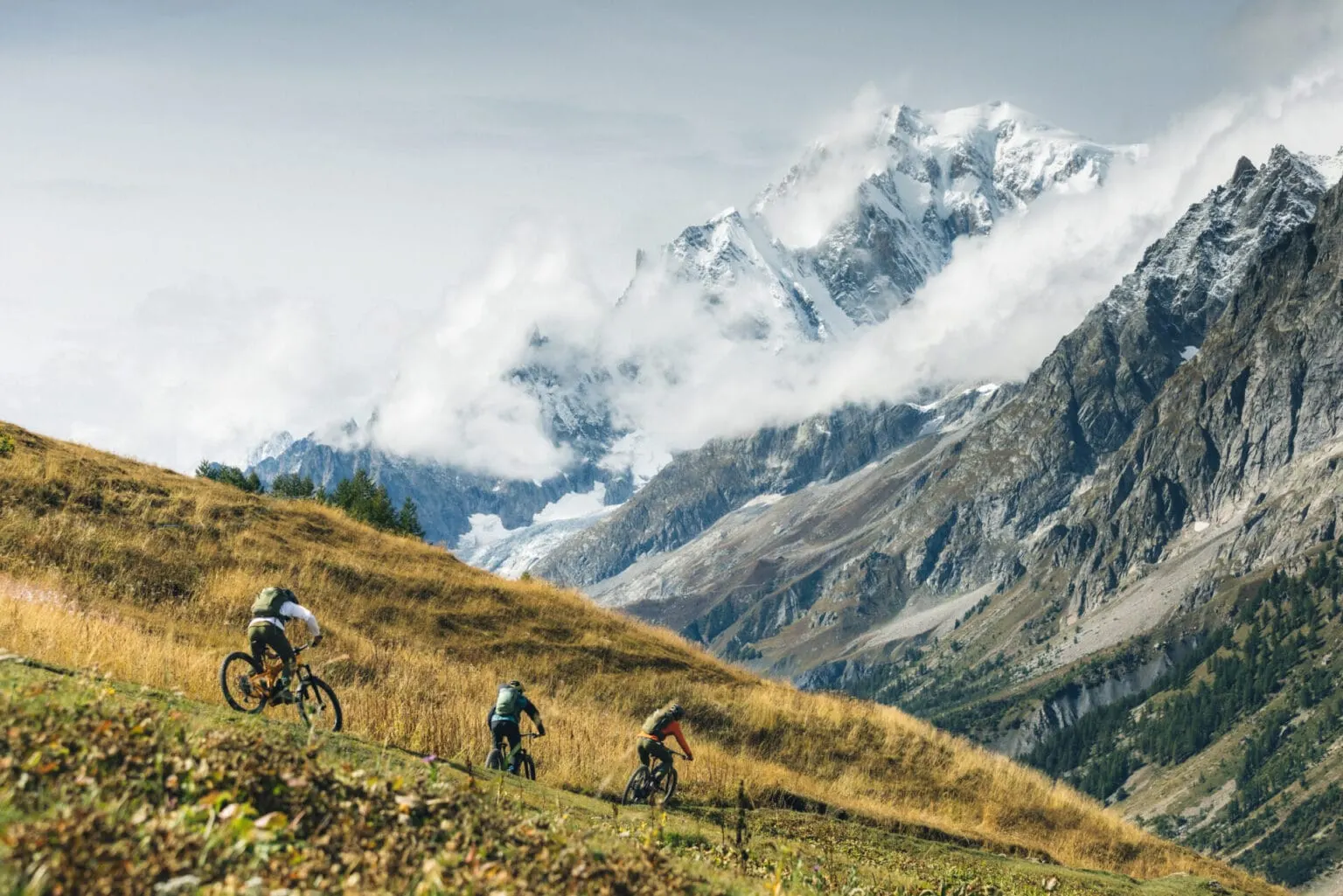 A group riding above Val Ferret, facing the Mont Blanc massif